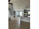 Open-concept living room featuring wainscotting, wood floors, a chandelier, and lots of natural light at 1708 Blue Lake Cir, Punta Gorda, FL 33983