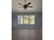 Bright living room featuring light blue walls, wood floors, and a ceiling fan at 1708 Blue Lake Cir, Punta Gorda, FL 33983