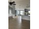 Open-concept living room featuring wainscotting, wood floors, a chandelier, and lots of natural light at 1708 Blue Lake Cir, Punta Gorda, FL 33983
