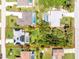 An aerial shot showcases the property's layout, pool, landscaping, and proximity to neighboring homes at 18147 Brazil Ave, Port Charlotte, FL 33948