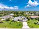 Aerial view of a well-maintained home, lush greenery, and solar panels on the roof at 18147 Brazil Ave, Port Charlotte, FL 33948