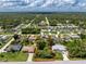 An aerial view shows a single-Gathering house with solar panels, a pool, and a large lot outlined in red at 18147 Brazil Ave, Port Charlotte, FL 33948