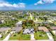Aerial view of a property with an outlined lot, showcasing the home, landscaping, and surrounding neighborhood at 18147 Brazil Ave, Port Charlotte, FL 33948