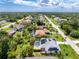 Enjoy this aerial view of a single-Gathering home featuring solar panels, a screened-in pool, and a well-manicured lawn at 18147 Brazil Ave, Port Charlotte, FL 33948