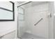 Bathroom with clear glass shower, gray tile and grab bar at 18147 Brazil Ave, Port Charlotte, FL 33948