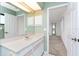 Bathroom featuring a vanity, large mirror, and doorway to the bedroom at 18147 Brazil Ave, Port Charlotte, FL 33948