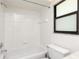 Bright bathroom featuring a tub with tile surround and a large window at 18147 Brazil Ave, Port Charlotte, FL 33948