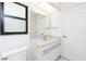 Bathroom with a white vanity, marble countertop, and a large mirror at 18147 Brazil Ave, Port Charlotte, FL 33948