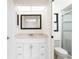 Bathroom with a light pink vanity, a framed mirror, and a glass-enclosed shower at 18147 Brazil Ave, Port Charlotte, FL 33948