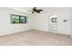 Bedroom with neutral carpet, ceiling fan, and ensuite bathroom access at 18147 Brazil Ave, Port Charlotte, FL 33948