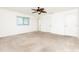 Bright bedroom with carpeted floors, ceiling fan, and windows offering natural light at 18147 Brazil Ave, Port Charlotte, FL 33948
