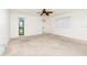 Spacious bedroom with carpeted floors, ceiling fan, and three windows offering natural light at 18147 Brazil Ave, Port Charlotte, FL 33948