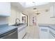 Clean kitchen space with white cabinets, stainless steel appliances, and tile floors at 18147 Brazil Ave, Port Charlotte, FL 33948