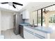 Modern kitchen with stainless steel appliances, tiled flooring, and view to the backyard at 18147 Brazil Ave, Port Charlotte, FL 33948