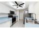 Well-lit kitchen featuring stainless steel appliances, tile floors, and a skylight above at 18147 Brazil Ave, Port Charlotte, FL 33948