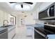Bright kitchen with stainless steel appliances and view to other rooms in the house at 18147 Brazil Ave, Port Charlotte, FL 33948