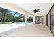 Enjoy outdoor living in this large covered lanai with a ceiling fan and views of the sparkling pool and lush landscaping at 18147 Brazil Ave, Port Charlotte, FL 33948