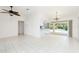 Open living area with tile flooring, a ceiling fan, and seamless access to outdoor entertaining by the pool at 18147 Brazil Ave, Port Charlotte, FL 33948