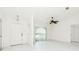 Bright living room featuring tile flooring, a ceiling fan, and large windows providing abundant natural light at 18147 Brazil Ave, Port Charlotte, FL 33948