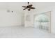 The spacious living room boasts tile flooring, natural light, and neutral paint, creating a welcoming atmosphere at 18147 Brazil Ave, Port Charlotte, FL 33948