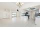Bright and airy living room showcasing tile floors, and views to the kitchen with modern appliances at 18147 Brazil Ave, Port Charlotte, FL 33948