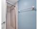 Tiled shower with glass door and adjacent blue wall with towel rack in this bright bathroom at 19505 Quesada Ave # Tt101, Port Charlotte, FL 33948
