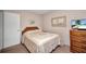 Neutral bedroom featuring a double bed, dresser, and decorative wall art at 19505 Quesada Ave # Tt101, Port Charlotte, FL 33948