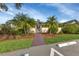 Community entrance with lush landscaping and secure gated entry for residents at 19505 Quesada Ave # Tt101, Port Charlotte, FL 33948
