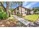 Exterior of the condo with well-manicured lawn and tropical landscaping at 19505 Quesada Ave # Tt101, Port Charlotte, FL 33948