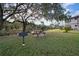 Community grilling area with a charcoal grill and picnic table, ideal for outdoor gatherings at 19505 Quesada Ave # Tt101, Port Charlotte, FL 33948