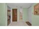 Hallway with a view of a bathroom, bedroom, and exterior access at 19505 Quesada Ave # Tt101, Port Charlotte, FL 33948