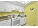 Kitchen features white cabinets, modern appliances, and ample counter space at 19505 Quesada Ave # Tt101, Port Charlotte, FL 33948