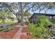 Mature trees, lush landscaping, and stone pathways line the exterior of the property at 19505 Quesada Ave # Tt101, Port Charlotte, FL 33948