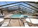 Large community pool featuring an indoor/outdoor enclosure, with plenty of room for tables and chairs at 19505 Quesada Ave # Tt101, Port Charlotte, FL 33948