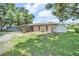 Expansive backyard with lush greenery and a screened-in lanai for outdoor enjoyment at 2131 Amanda Dr, Sarasota, FL 34232