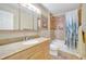 Bathroom with a granite countertop, decorative mirror, and tiled shower/tub combo at 2131 Amanda Dr, Sarasota, FL 34232