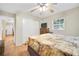Comfortable bedroom featuring two windows, wood furniture, tile flooring, and a ceiling fan at 2131 Amanda Dr, Sarasota, FL 34232