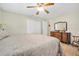 This bedroom has tile floors, neutral paint, a ceiling fan, and a closet with double doors at 2131 Amanda Dr, Sarasota, FL 34232