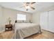 Cozy bedroom with a ceiling fan, tile floors, neutral paint and a double door closet at 2131 Amanda Dr, Sarasota, FL 34232