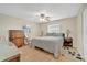 Comfortable bedroom featuring a ceiling fan, neutral paint, and warm, inviting tile flooring at 2131 Amanda Dr, Sarasota, FL 34232