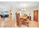 Dining area featuring a wooden dining set and tile flooring, next to kitchen and living room at 2131 Amanda Dr, Sarasota, FL 34232
