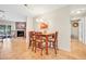 Bright dining area featuring a wooden table and chairs, complemented by a modern chandelier at 2131 Amanda Dr, Sarasota, FL 34232