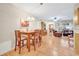 Open dining area featuring a wooden table with 4 chairs, seamlessly connected to the living room at 2131 Amanda Dr, Sarasota, FL 34232
