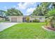 Inviting single-story home featuring a well-maintained lawn and attached garage at 2131 Amanda Dr, Sarasota, FL 34232
