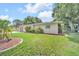 Charming single-story home with a well-manicured lawn, lush landscaping, and a side-entry two-car garage at 2131 Amanda Dr, Sarasota, FL 34232