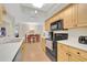 Functional kitchen features updated appliances, white countertops, and ample storage space at 2131 Amanda Dr, Sarasota, FL 34232