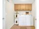 Well lit laundry room featuring tile floors and a modern washer and dryer at 2131 Amanda Dr, Sarasota, FL 34232