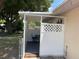 Cozy private seating area, enclosed with decorative lattice and accessible from the main house at 2131 Amanda Dr, Sarasota, FL 34232