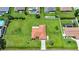 Aerial view of a meticulously kept home with a bright orange roof and lush green lawn at 23141 Corvin Ave, Port Charlotte, FL 33954
