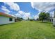 Large, well-maintained backyard with a privacy fence and green grass at 23141 Corvin Ave, Port Charlotte, FL 33954